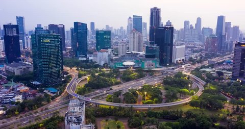 JAKARTA, Indonesia - November 21, 2018: Time lapse/Hyperlapse of Semanggi highway intersection and modern office buildings at dust time in Jakarta city. Shot in 4k resolution
