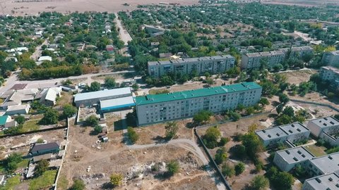  Beautiful bird`s eye shot of Askania-Nova village, the heart of Taurida steppe biosphere reserve with various buildings, alleys, and gardens in summer 