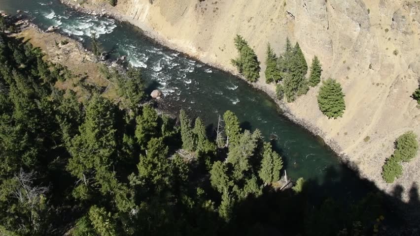 Yellowstone River at Calcite Springs. Camera tilts up revealing Calcite Springs to the left of the river. Camera handheld.