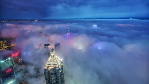 SHANGHAI CHINA- CIRCA JUNE 2017: Over the sea of clouds, aerial view of the modern buildings with Huang-Pu River circa June 2017 in Shanghai, China.