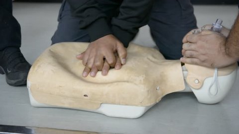 First aid cardiopulmonary resuscitation training on adult manikin. Close up.