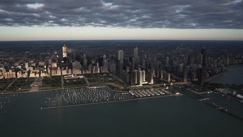 Chicago Circa-2015, morning aerial view from high altitude over Lake Michigan focusing on Grant Park, Buckingham Fountain, and the city skyline with morning light reflecting off of the buildings
