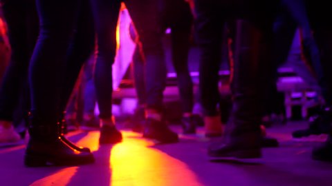 Legs of dancing people at the party music club