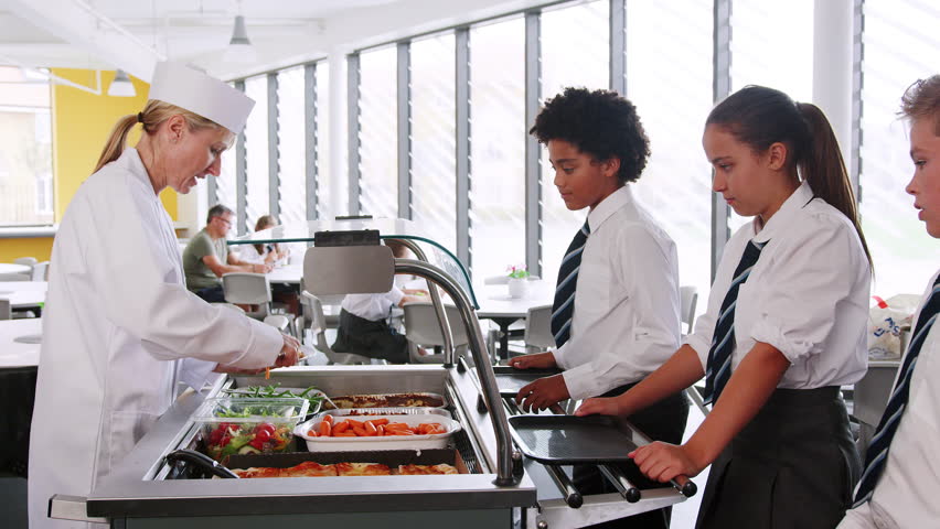 High School Students Wearing Uniform Being Served Food In Canteen Royalty-Free Stock Footage #1019964310