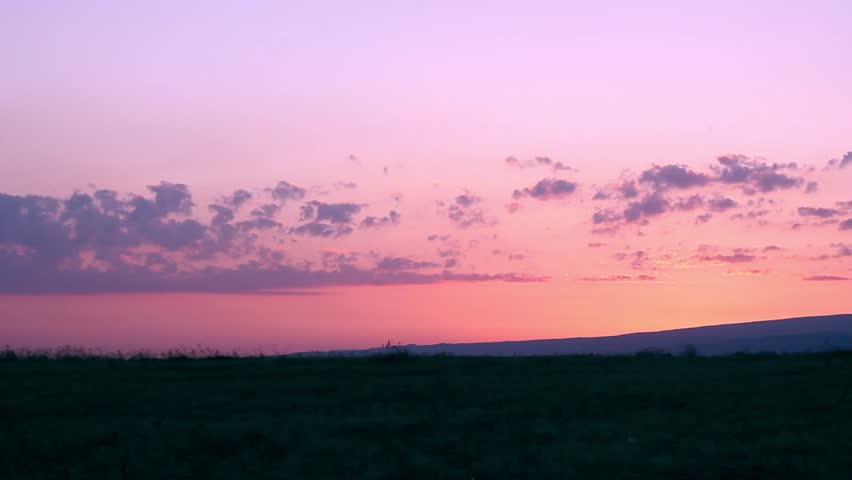 Beautiful scenic sunset with rays of sun shining through clouds, nice golden horizon, fast motion cloudscape.