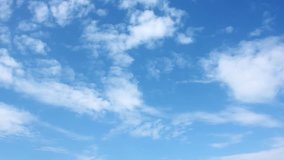 Blue soft clear sky, white rolling & fast motion beautiful clouds, time lapse. Summer good time, wind fast moving cloudscape away in horizon, real colours. 4K.