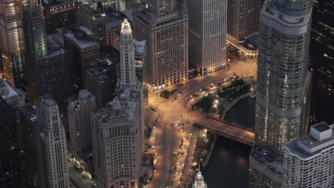 Chicago, Illinois - Circa-2015: Aerial view slow tilt up Trump International Hotel and Tower at dusk with Chicago Skyline and landmarks in background