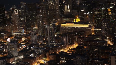 Chicago, Illinois - Circa-2015: Telephoto aerial view of the city skyline at night, moving toward the Merchandise Mart from Near North Side 