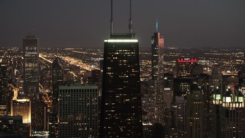 Chicago, Illinois - Circa-2015: Telephoto aerial view passing by John Hancock Center and Trump International Hotel & Tower Chicago at night
