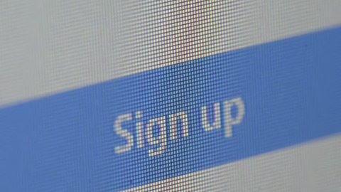 Closeup of computer screen with cursor pointing sign up menu on web browser