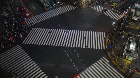 Tokyo Japan 10 Nov 2018 : Aerial time lapse view over Shibuya crossing with many pedestrians and vehicles crossing the junction in Tokyo Japan at night time. Shibuya is fashion shopping entertainment.