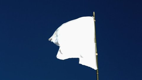 White flag waving in the blue sky 