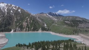 Aerial video of a beautiful mountain lake in spring. Kazakhstan. Big Almaty lake.