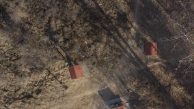 Flying over picnic houses in the woods 4K drone footage