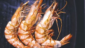 Giant prawns on hot pan stir fried in butter VIDEO CLIP