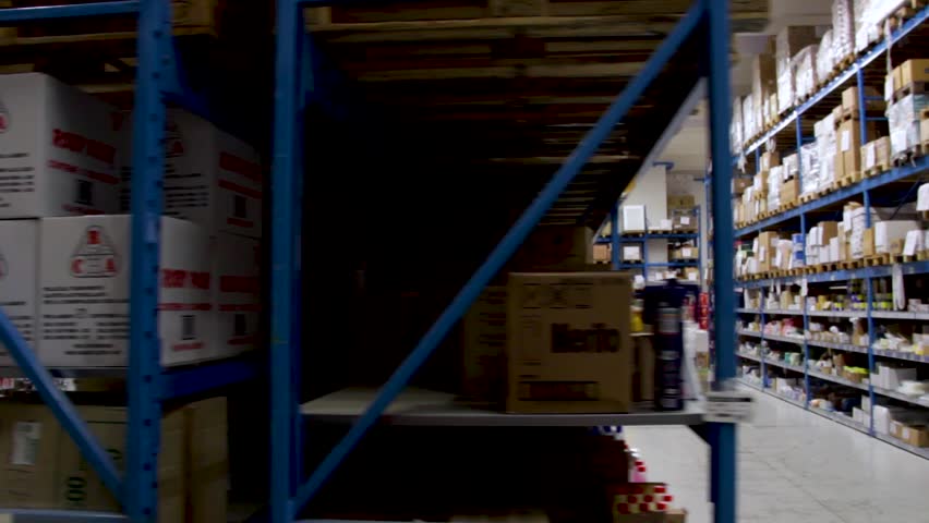 Long slider shot of a Food, Grocery and Households warehouse in Italy. Shelves full of stock Royalty-Free Stock Footage #1020009976