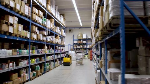 Long slider shot of a Food, Grocery and Households warehouse in Italy. Shelves full of stock