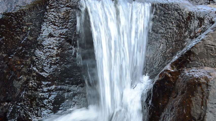 water falling on river pass rock and stone in forset