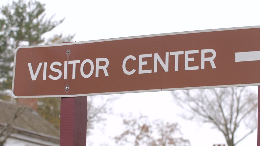 Brown visitors center sign close up
