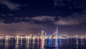 Auckland, New Zealand at night in beautiful timelapse video. Bright lights of the city centre with all iconic buildings and clouds flying above the city.