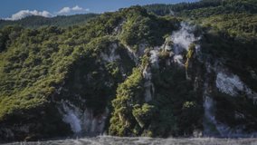 Volcanic smoking hill and hot lake in Waimangu Volcanic Valley in New Zealand, popular tourist attraction. Timelapse video.