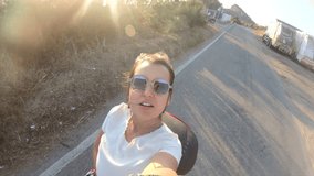 Happy young woman riding scooter motorbike on Ponza island at sunset. Couple shooting selfie video in front of the sea 27_Ponza_Collinetta_GOPRO_03