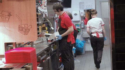 Moscow, Russia - September 16, 2018: Men and Women Works in the Kitchen Fast Food Restaurant Chain. McDonald's Kitchen Staff in the working process. Workflow Kitchen Fast Food Cafe