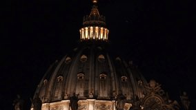 Extreme zoom detail night video of statues and architectural masterpieces in iconic Saint Peter Basilica in the heart of Vatican city, Rome, Italy