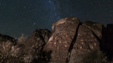 Motion controlled astrophotography time lapse with dolly tracking & zoom in motion of Milky Way galaxy over ancient Native American petroglyphs in Eastern Sierra, California