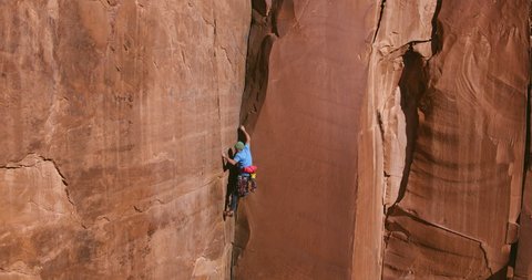 Man rock climbing extreme vertical rock climb