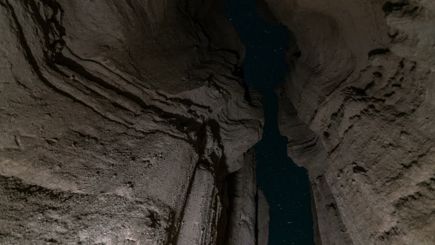 Astro timelapse with dolly tracking motion of stars through sandstone slot canyon at Red Rock Canyon State Park in Mojave Desert, California