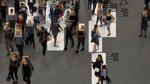 Crowded building with commuters walking. Artificial intelligence and facial recognition are used for surveillance purposes. Individual data showing sex, race and clothing. Deep learning. Futuristic.