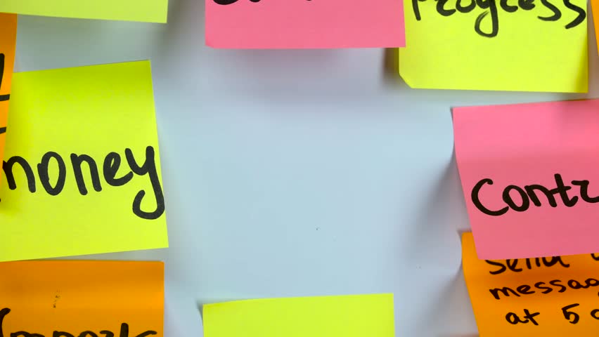 Hand glues a sticker with an inscription digital on a board with stickers