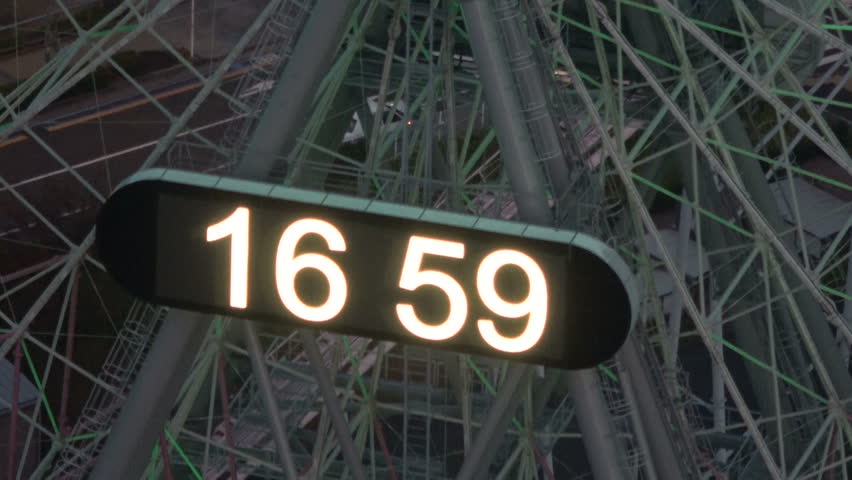 Zoom out shot of Ferris Wheels at night in Yokohama, Japan