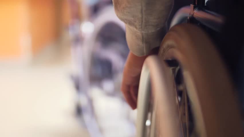 disabled man safely drives wheelchair in corridor institution slow motion Royalty-Free Stock Footage #1020052573