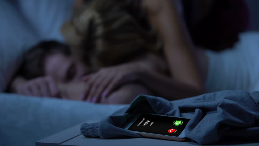 Wife incoming call, husband sleeping on bed after night with mistress, betrayal