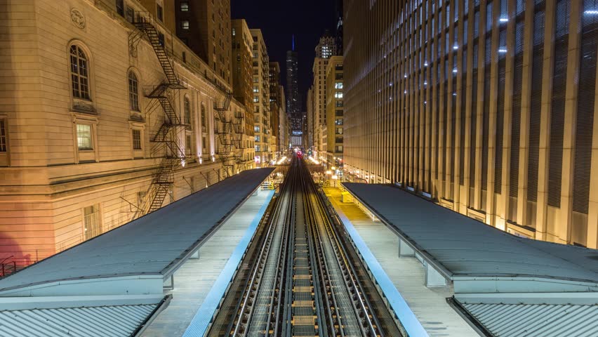 Night timelapse of Chicago loop aerial subway loop station metro train track