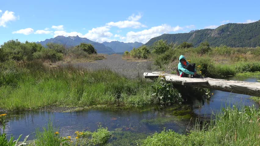 Girl is sitting on a creek