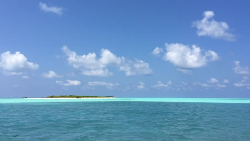 Maldives island time lapse of clouds over the sea.