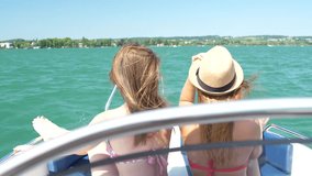 Two pretty amazing girls, blond and brunette ride on a speed boat Video 4K
