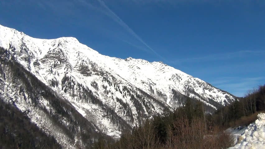 Winter Weather. Snowy montains against blue sky.