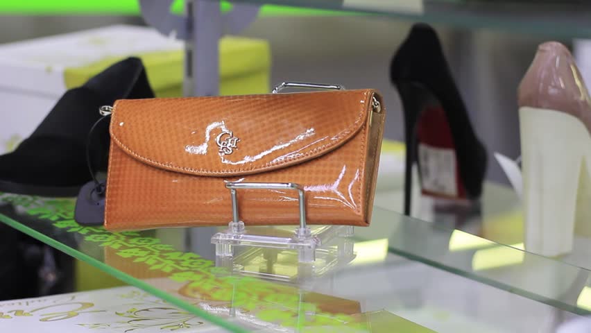 female hands chooses a female handbag in the store