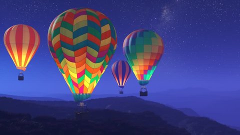 Colorful, glowing hot air balloons flying over the mountains during a night. Four large multi-colored vibrant balloons slowly rising against a dark sky with stars. Travel, adventure, festival.
