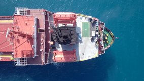 Aerial footage of a large Cargo ship at sea.