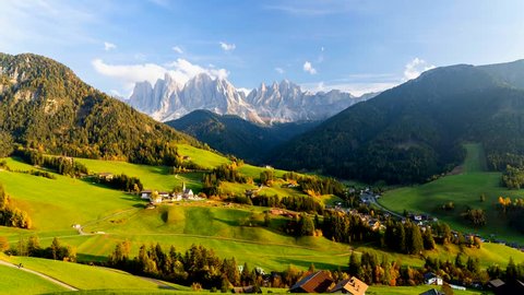 Time lapse of Santa Maddalena village with majestic Dolomite mountains in background, Val di Funes valley, Trentino Alto Adige region, Italy, Europe. Sunset in a  Italian Dolomites.