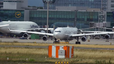 FRANKFURT AM MAIN, GERMANY - JULY 19, 2017: Middle distance shot of Airbus A340 with Star Alliance livery rolling down the taxiway after arrived at Frankfurt am Main airport