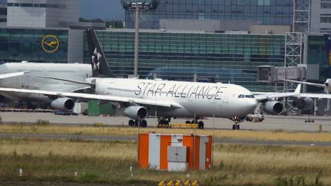 FRANKFURT AM MAIN, GERMANY - JULY 19, 2017: Middle distance shot of Airbus A340 with Star Alliance livery rolling down the taxiway after arrived at Frankfurt am Main airport