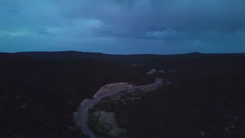 A stretch of highway in the New Mexican mountains in the evening