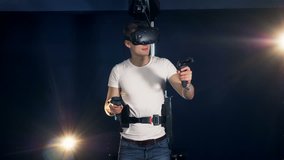 Young man playing games in VR equipment. Robotic VR cybernetic gaming system.