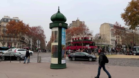 Paris, France - November 21, 2018: Advertisign cylindrical column (Morris column) features advertisement for a movie on the place de l'Ecole Militaire
